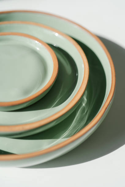istock A large stack of ceramic cups in pastel green color. 1326200832