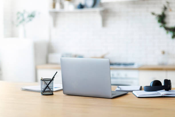 istock Home workplace with laptop, notebook and headphones remote work or online education concept 1326200933