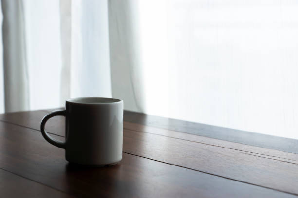 istock Coffee mug on the wood table in the morning time with soft light. 1326201601