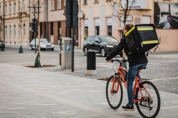 istock Food delivery man riding bicycle on street 1326201901