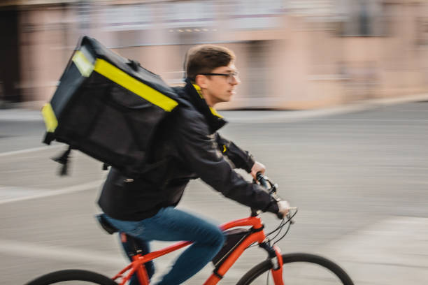 istock Delivery man riding bicycle at speed 1326202509