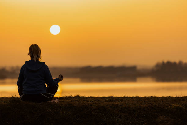 istock Woman meditating near lake 1326204493