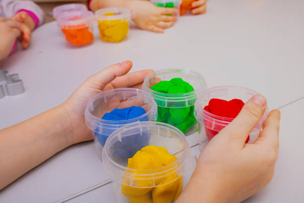 istock young happy children playing with colorful dough, 1326205130