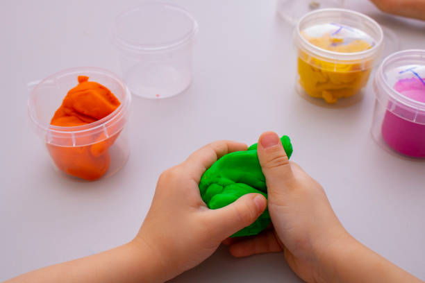 istock Child playing with colorful clay making toys 1326205454