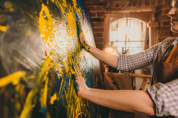 istock Talented female artist draws with her hands on the large canvas 1326206500