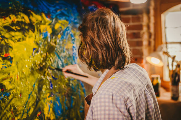 istock Unrecognizable artist draws with a hand on the canvas 1326207473