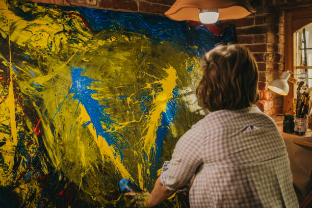 istock Artist pouring paint on picture 1326208056