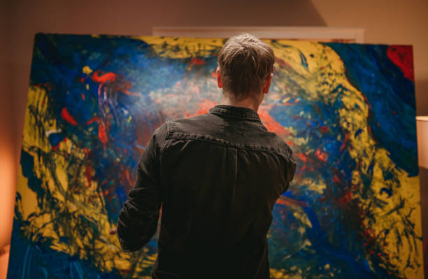istock Male artist looking at his artwork 1326208307