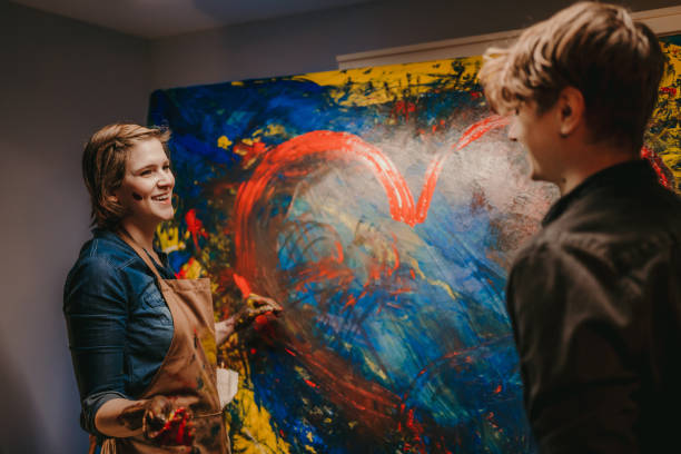 istock Female artist smiling at her partner while creating artwork 1326208462
