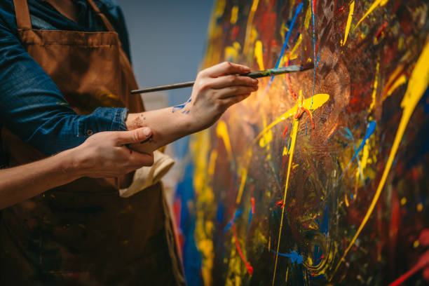 istock Close up of a couples hands painting on canvas 1326208463