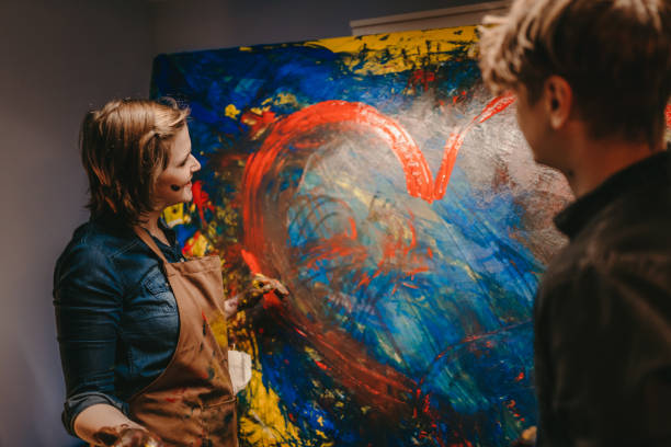 istock Female artist looking at her creative artwork 1326208565