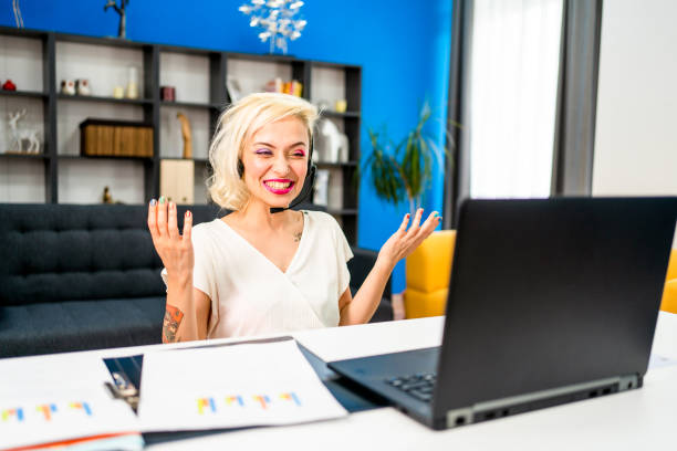 istock Young woman doing a video call on her laptop 1326208576
