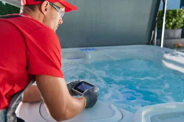 Photo of Garden SPA Technician Testing Hot Tub Remote