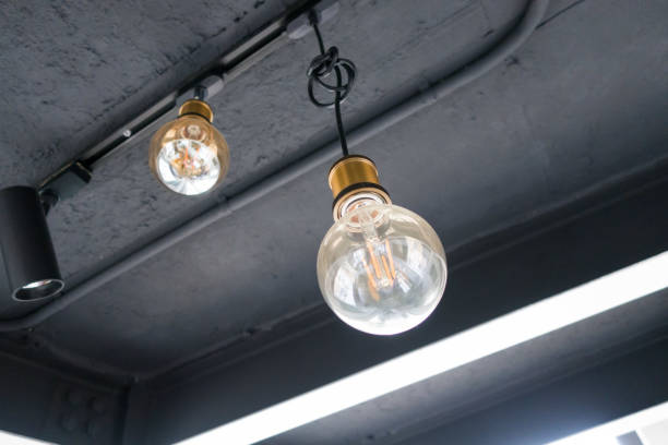 istock Old dusty light bulb glowing in the dark. 1326209420