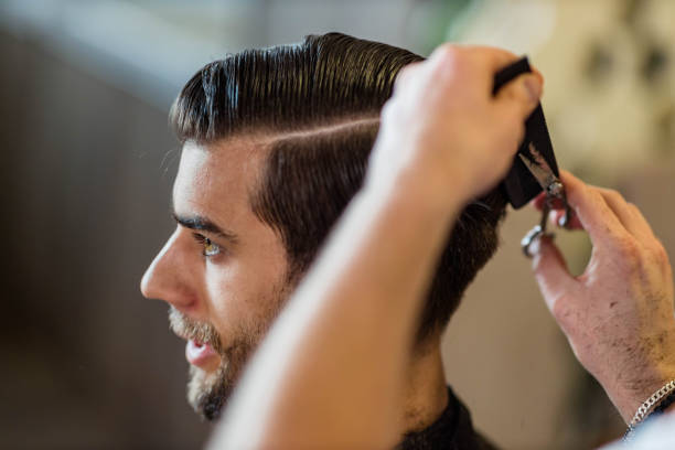 istock Young man having a haircut at barber shop. 1326211164
