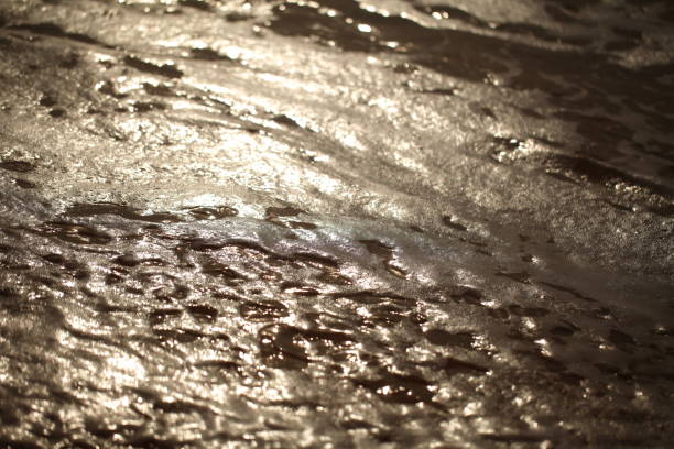 istock foam on sandy tropical ocean beach 1326212097