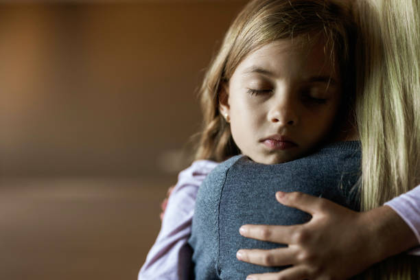 istock Affectionate little girl embracing her single mother at home. 1326212213