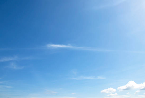 The sky is large, bright, beautiful and has white clouds.