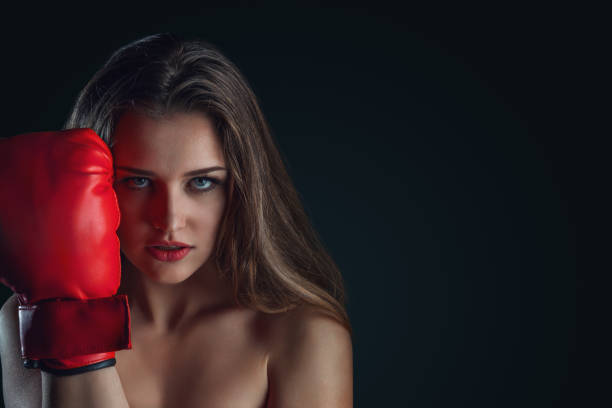 istock Young woman with boxing gloves 1326215413