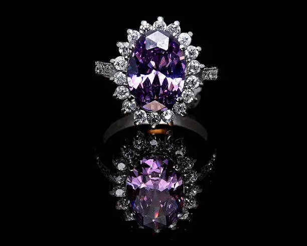 Its a amethysts silver ring on black background with natural reflection