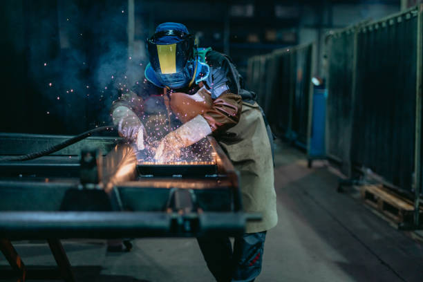 istock Welder welding in metal shop 1326217779