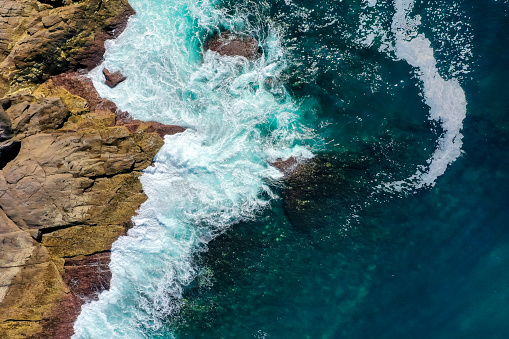 Top down drone photography of the ocean with waves