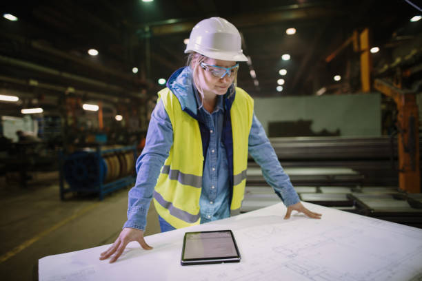 istock Female engineer working on blueprint in factory 1326218489