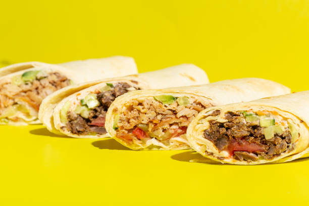 istock Doner roll shawarma with chicken and vegetables on yellow 1326218887