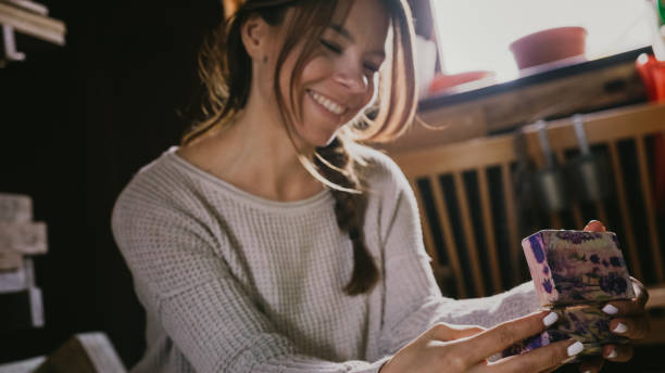 istock Young girl smiling while looking at a small box 1326218988