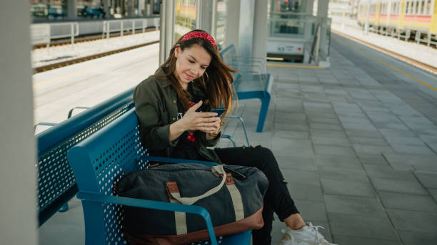 istock Pretty young girl looking at smartphone on the platform 1326219540