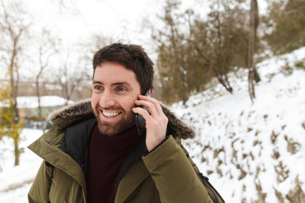 istock Handsome young man wearing winter jacket standing 1326221820