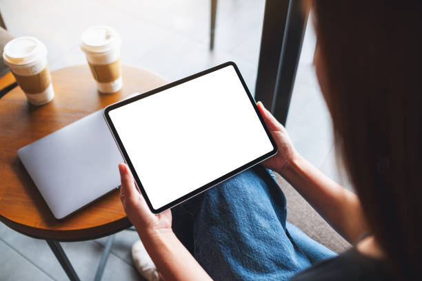 istock a woman holding digital tablet with blank white desktop screen 1326222039