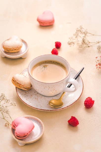 istock Cup of coffee with sweet macarons on kitchen table 1326222168