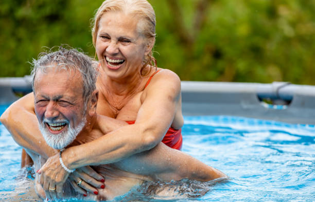 istock Cheerful senior couple resting in a swimming pool 1326222238