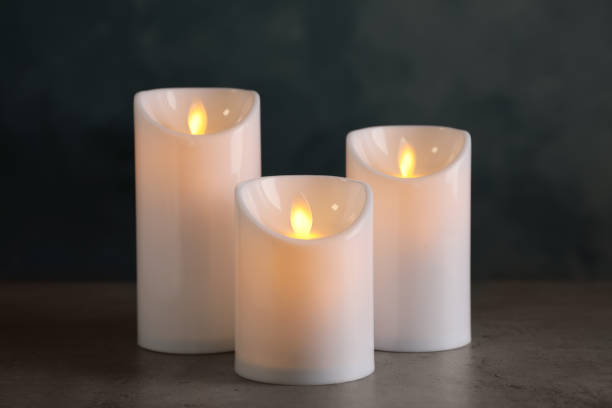 istock Beautiful decorative LED candles on grey table 1326223079