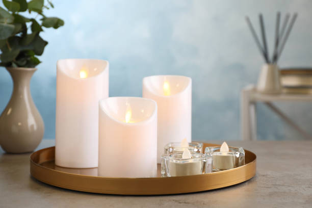 istock Beautiful decorative LED candles on grey table 1326223192