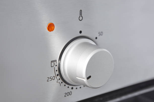istock Oven cooking temperature control knob. Kitchen equipment panel detail 1326223424