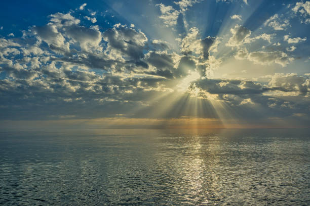 istock The Black Sea in the evening with the setting sun. Godrays come from the bright clouds illuminating the scene. Seaside landscapes, sunsets and sunrises, vacation and tourism. 1326224577