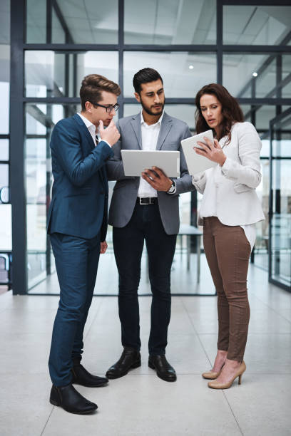 istock Shot of two professional coworkers using a digital tablet together at work 1326226308