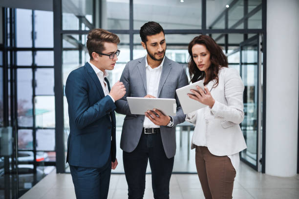 istock Shot of two professional coworkers using a digital tablet together at work 1326226335
