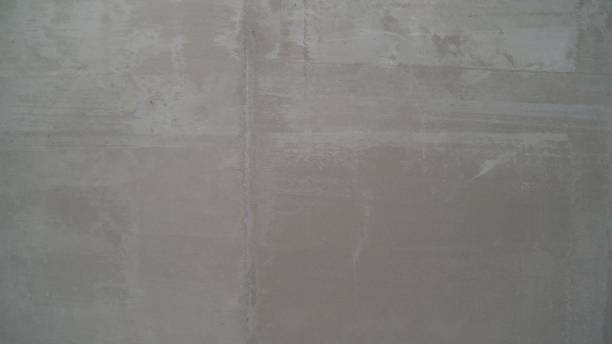 Plastering wall. Texture of a wall made of gray mortar stock photo
