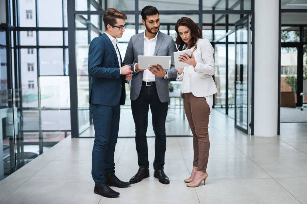 istock Shot of two professional coworkers using a digital tablet together at work 1326227174