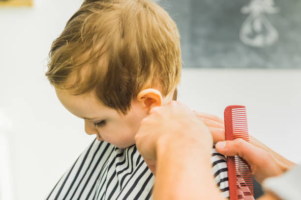 istock the little boy in a hairdressing salon 1326228643