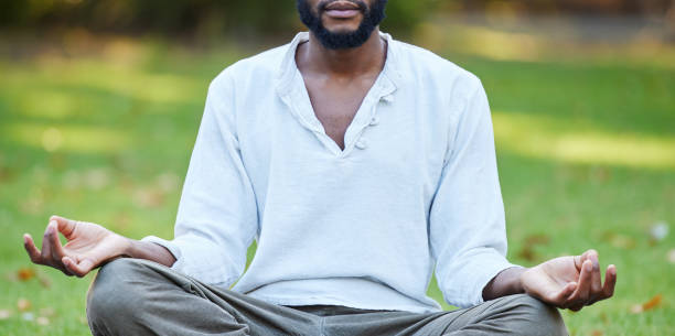 istock Cropped shot of an unrecognizable young man meditating while practicing yoga outside at the park 1326232111