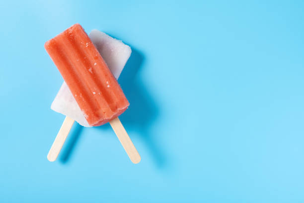 istock top view fresh red popsicle and white popsicle on a blue background 1326234172