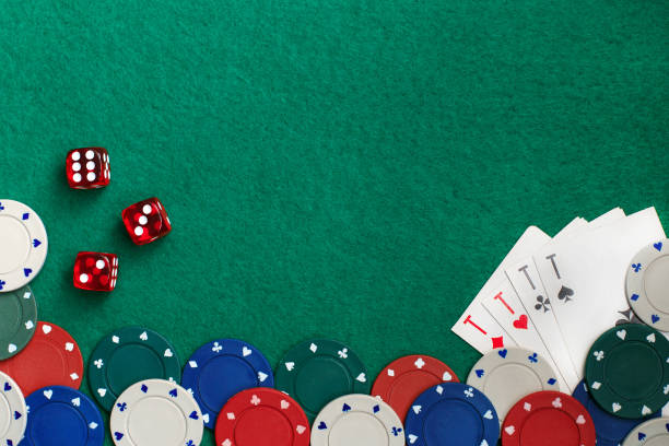 istock Playing cards,dices and poker chips from above on green poker table 1326235431