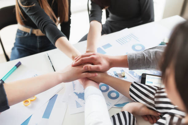 istock Group of people doing handshake and cross hands 1326236781