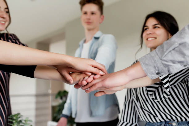 istock Group of people doing handshake and cross hands 1326236896