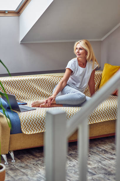 istock Pretty middle aged caucasian woman sitting on sofa 1326238970