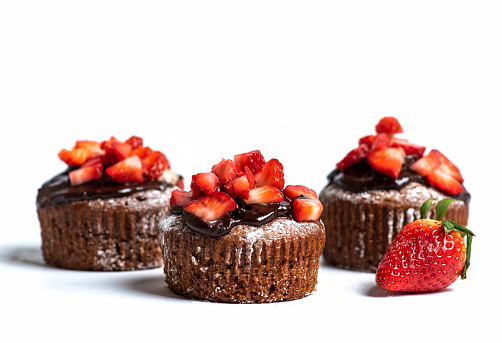 Homemade strawberry muffins chocolate brownies on white background with copy space